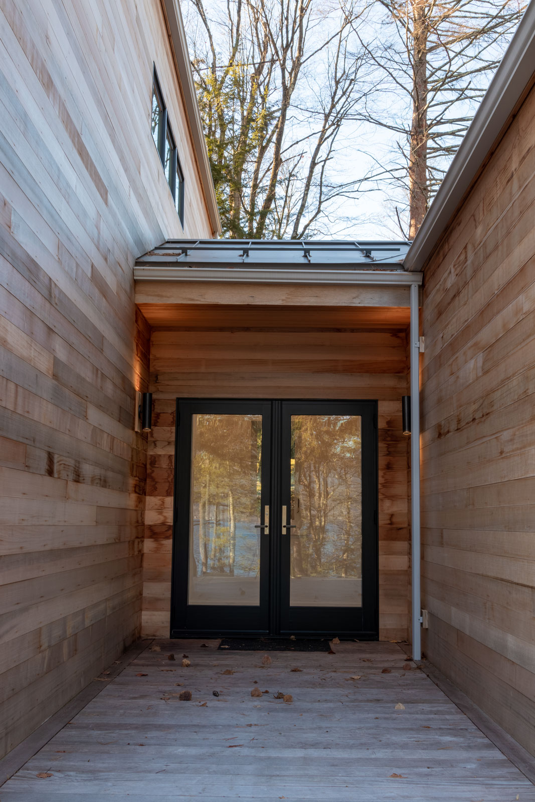 Enter this H-shaped guest cottage from the center. The entry is tucked in the heart of the patio. It's recessed space gives emphasis on the kitchen and living and the larger bedroom areas. 