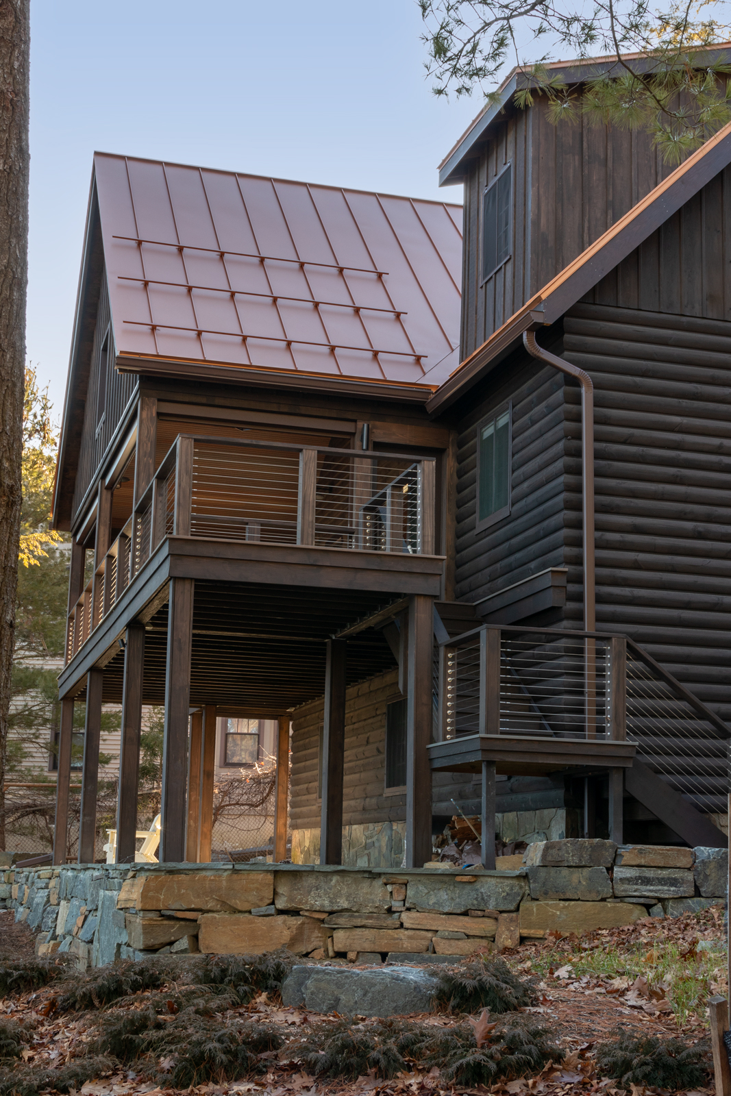 The attention to the details of the deck addition was paramount to success. The material selection for the design focused on harmonizing the colors and form of the existing cabin while selecting wood siding that blended with the natural surroundings of the shore. 