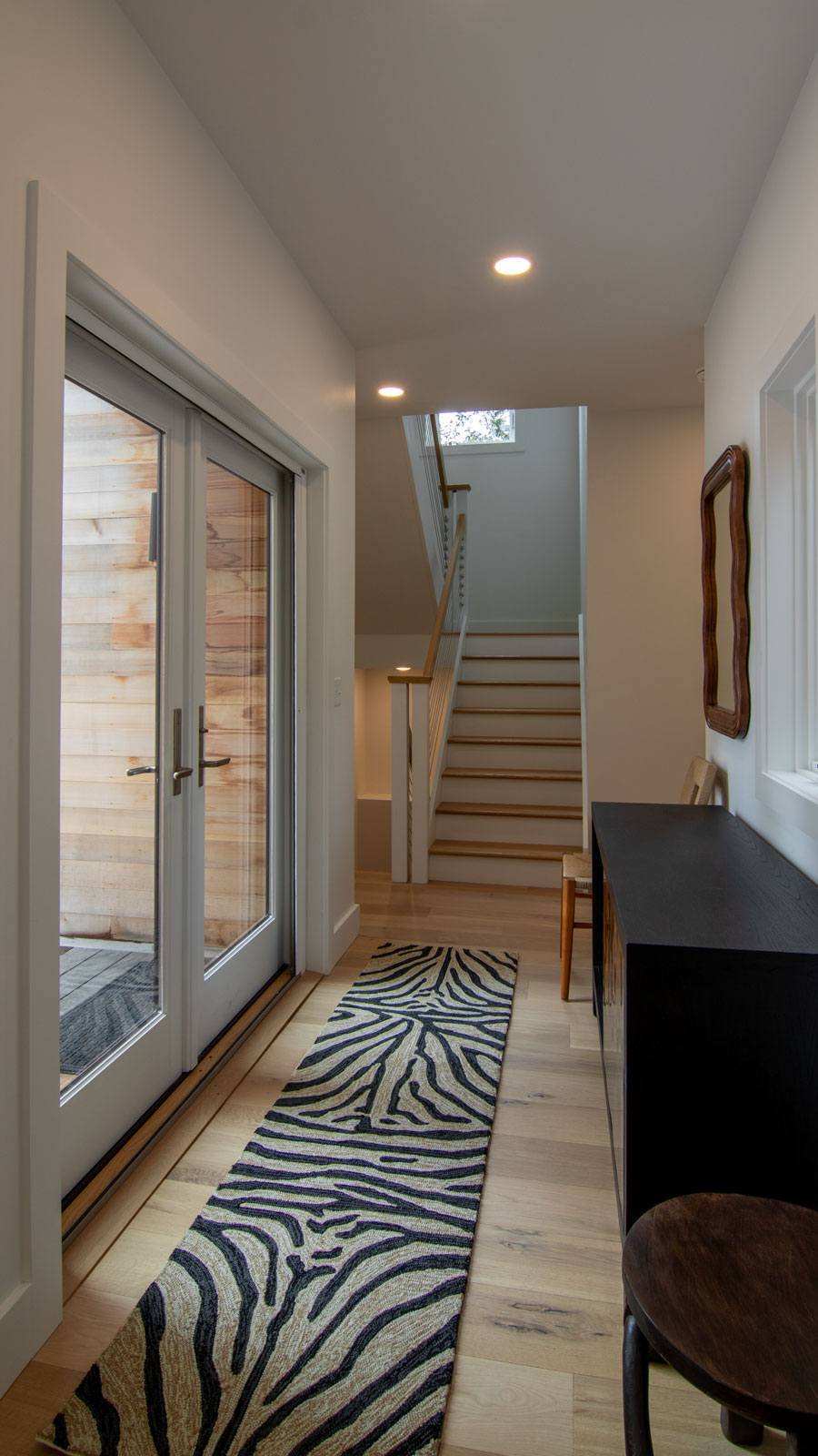 Rock View Entry Enter this H-shaped guest cottage from the center. The entry is tucked in the heart of the patio. It's recessed space gives emphasis on the kitchen and living and the larger bedroom areas.